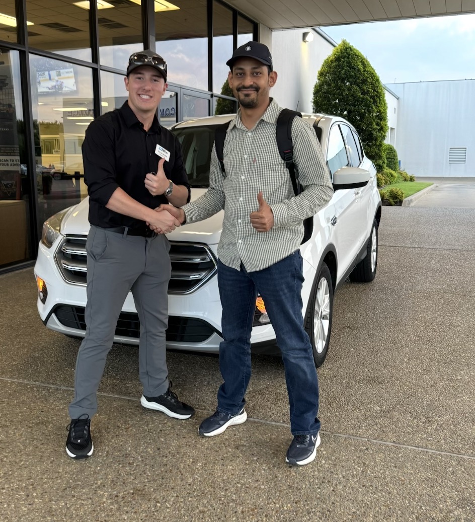 Customer and Rylan Beebe giving thumbs-ups in front of a white SUV