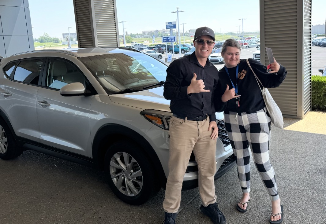 Customer celebrating her new SUV purchase with Rylan Beebe